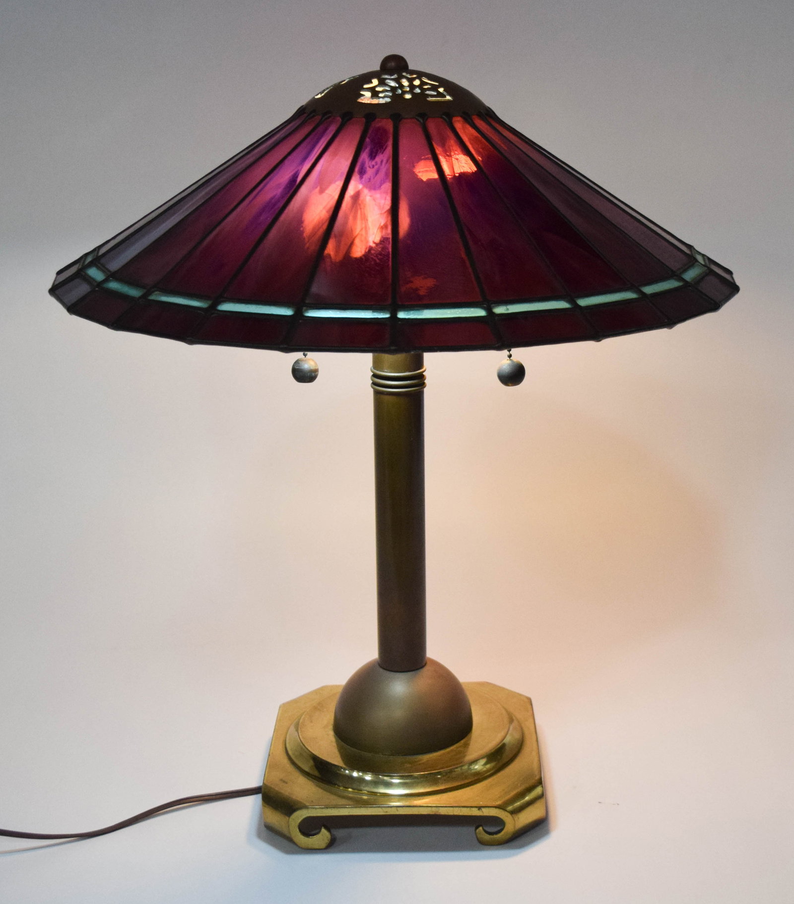 Crescent Brass Manufacturing Co. Leaded Slag Glass and Brass Table Lamp: Crescent Brass Manufacturing Co. Arts and Crafts style table lamp featuring a leaded slag glass shade and patinated brass base. The shade is finished with a pierced foliate-patterned metal heat cap an