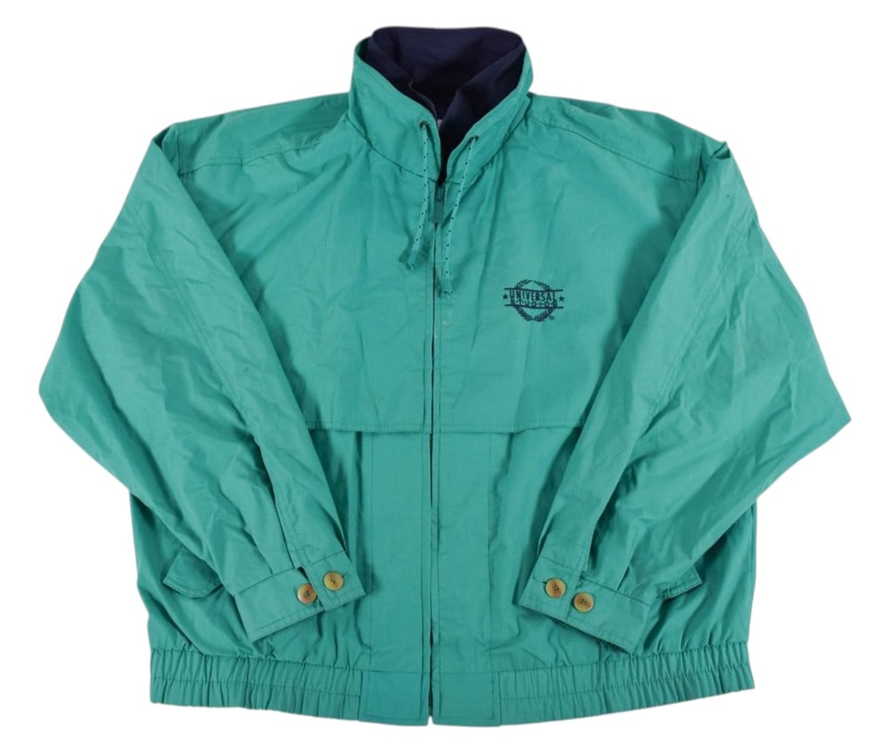 Peter Benchley's Universal Studios Windbreaker Jacket: Gear For Sports Universal Studios windbreaker jacket from the personal collection of Peter Benchley. The garment is constructed from a teal green cotton, polyester, and nylon blend fabric with a navy 