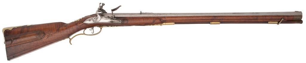 German Elliptical-Bore Jaeger Rifle by Sel Kopf: .76 caliber at widest point, 30" octagonal smoothbore barrel. Varnished walnut full stock with horn forend cap, carved cheekpiece, and sliding patchbox along with well-carved floral motifs in the 