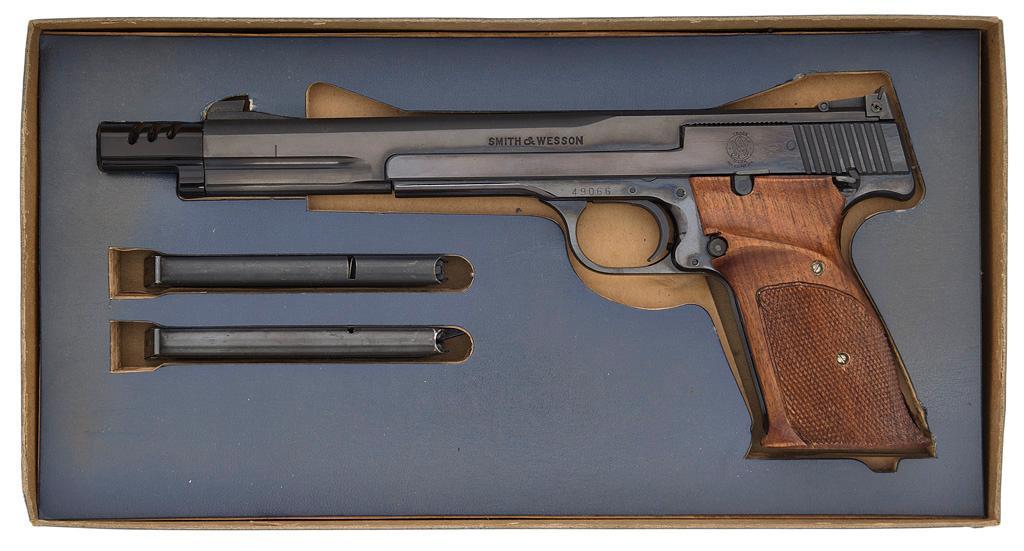 Smith & Wesson Model 41 Target Pistol in Original Box: .22 LR caliber, 7" barrel, S/N 49066. Blued finish with checkered wood grip. Blade front sight with adjustable target rear sight. Fitted with muzzle brake. Comes in original box with spare magazin
