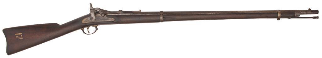 U.S. Model 1868 Springfield Trapdoor Rifle: .50-70 caliber, 32.5" barrel, S/N 7812. Breechblock is dated 1869, rear barrel sight leaf is missing. This is one of the rifles that was arsenal nickel finish. **Overall a good example of the nick