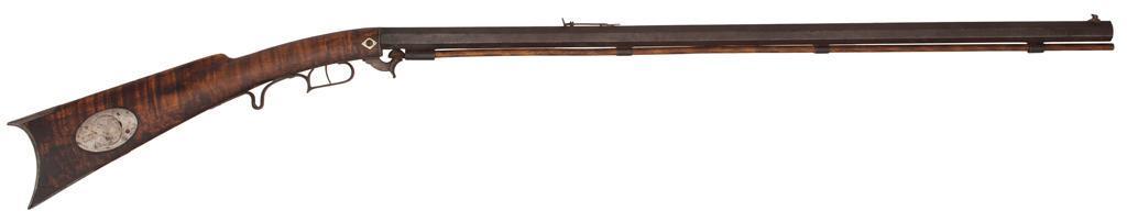 Percussion Underhammer By N.Kendall Windsor, Vermont: .45 caliber, 34" octagonal barrel. Marked on the top of the barrel "N. Kendall Windsor Vt.". Iron furniture with maple stock. Blade front sight, Notched rear barrel sight. Stock has an iro