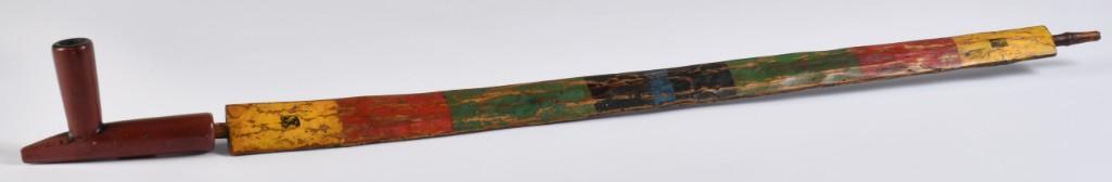 Calumet Pipe with Stem: 5" x 3.25" calumet pipe bowl of typical form with 28" x 1.5" carved polychrome stem. **Good condition overall. Some darkening of pipe with some carbon buildup in bowl from use. Stem with some wear to 