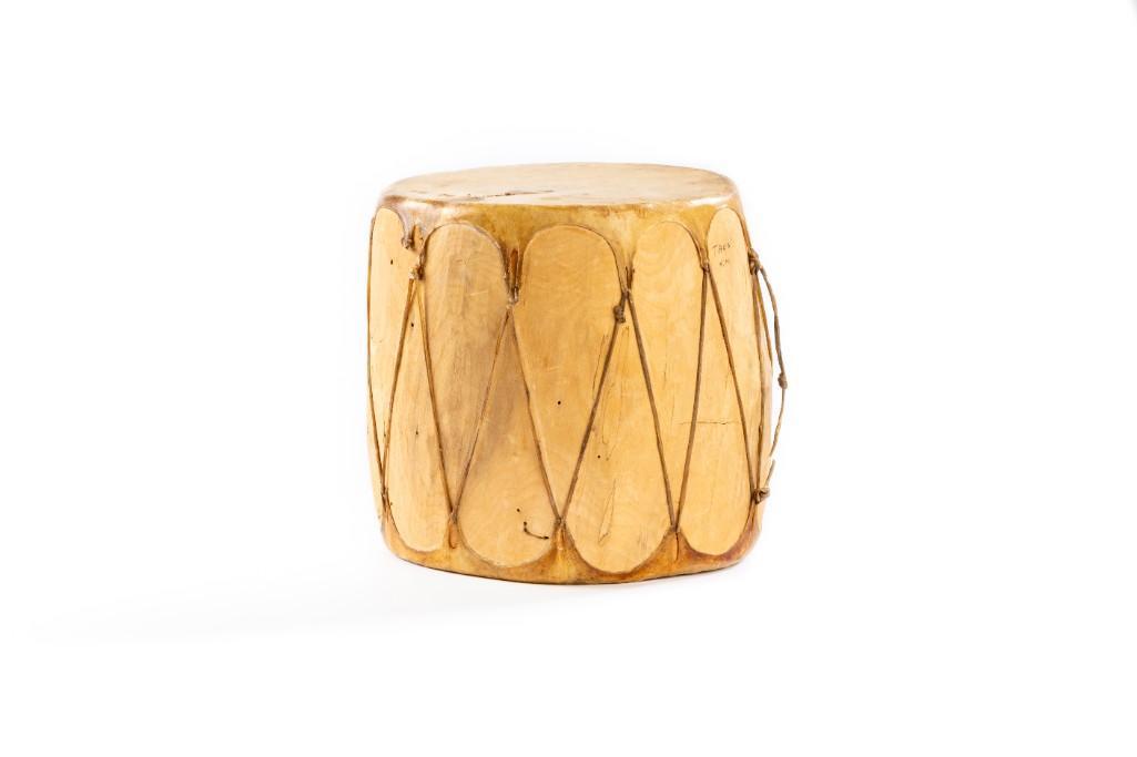 Southwest Hide & Wood Drum: 7" x 6.5" x 23" circumference. "Taos, N.M." Rawhide head,hide lacings, cottonwood body. **Some minor old repairs to head with some breakage of skin on lacing points. Some insect holes.** $100-$200