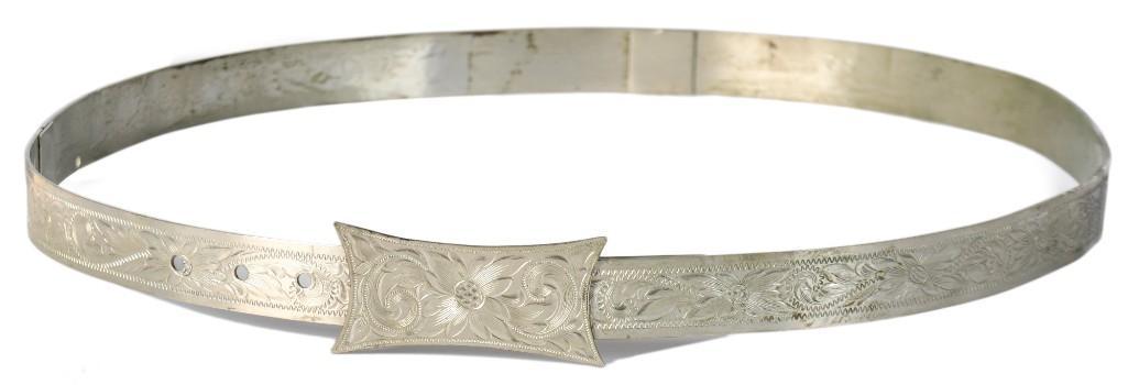 Engraved Hat Band Attributed to Bill Pickett: 22" circumference, adjustable to 25", .5" wide. Steel band engraved throughout with floral motifs and geometric borders. **Good condition overall. Some minor oxidation.** $200-$400