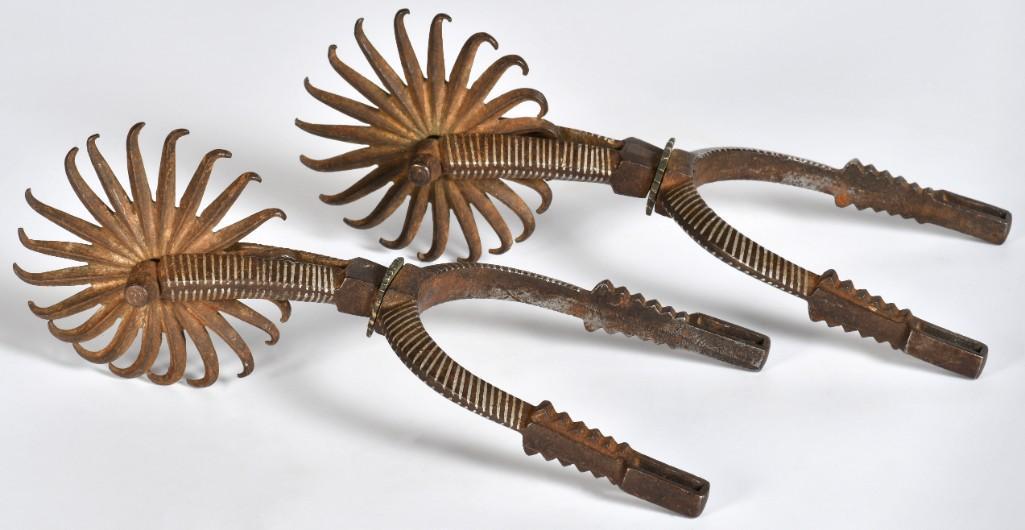 Good Pair of Silver Inlaid California Style Spurs: 8.5" x 4". Iron construction with two-piece heel hand and shank. German silver inlay on shank and heelband with 3.5" fan rowells. Late 19th-early 20th century. **Very good condition. Overall dark choc