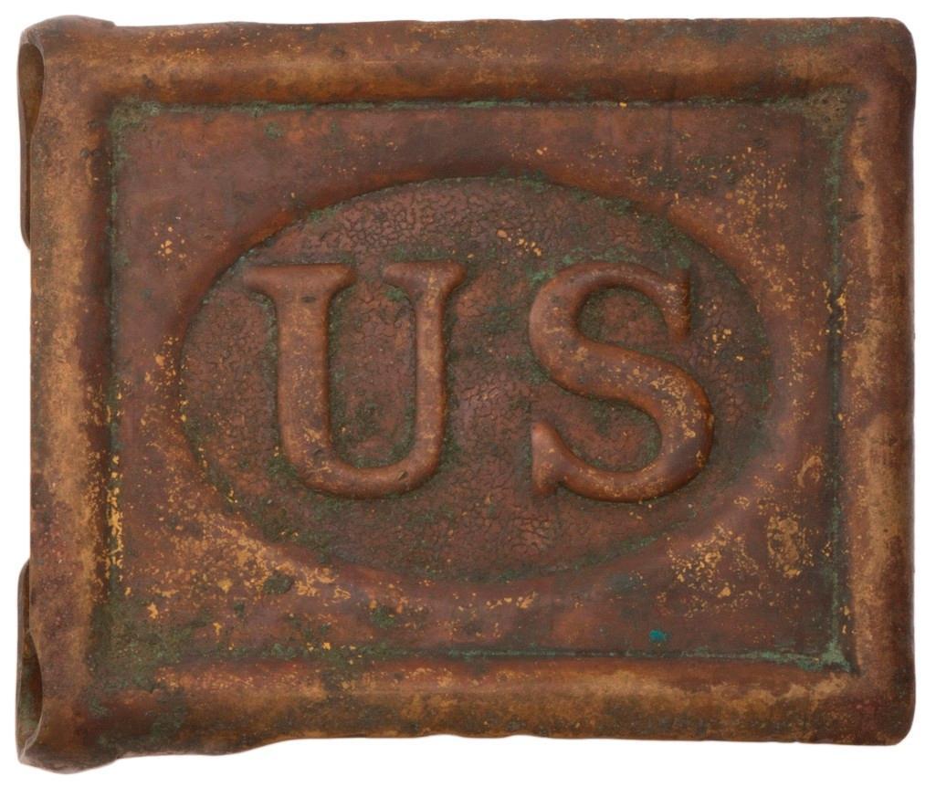 US Model 1881 Enlisted Mans Buckle: Brass one-piece construction with Mills patent markings. Label reads "FOUND IN AREA OF FT. MOHAVE 1968". **Good condition. Dark patination with some scattered bending and imperfections to brass.** $10