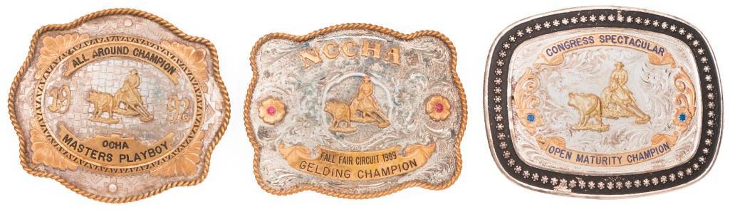 A Group of Three Silver Overlay Belt Buckles by Montana Silversmiths: American, 20th century. A group of three belt buckles from the OCHA and the NCCHA, allbuckles hand engraved with sterling silver plate hallmark by Montana silversmiths; largest 4.5 x 3.5 inches. **Ove