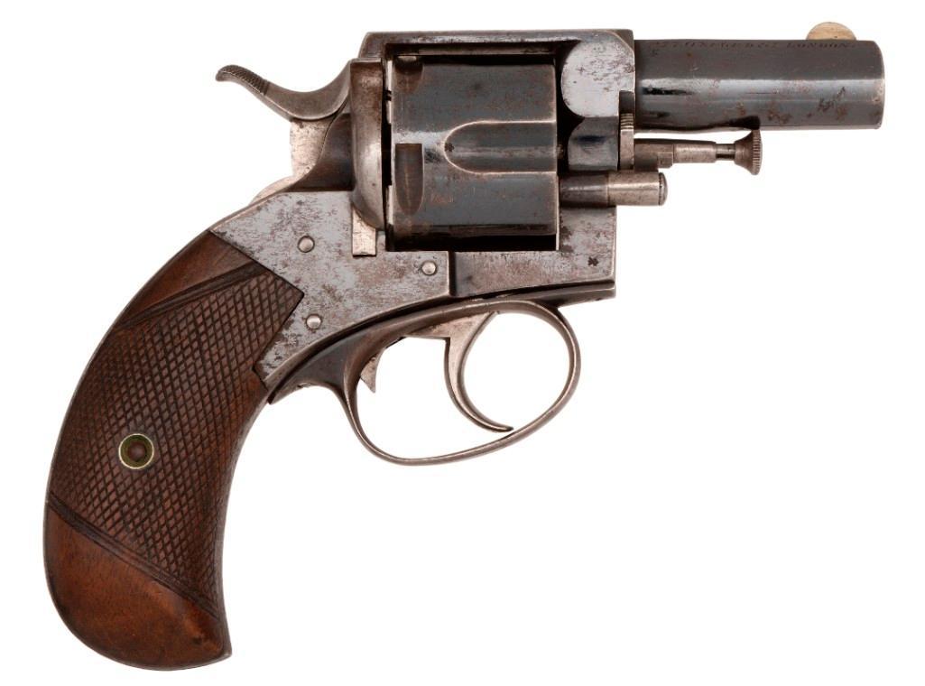 Webley No. 02 Revolver Retailed by E.M. Reilly & Co.: .450 caliber, 2" barrel, S/N 65425. Blued finish with checkered walnut grips, checkered hammer. Top of barrel marked E.M. Reilly & Co. 277 Oxford St. London. Fair condition, some of blue finis