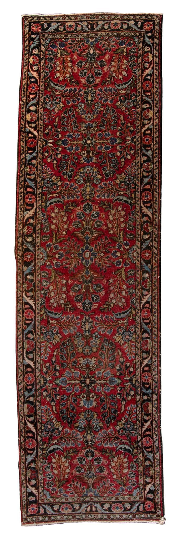 A Sarouk Runner Rug: Iran, 20th century. Sarouk runner; 110 x 31 inches. Overall good condition. Expected wear with age. No repairs or tears. Minor fraying to perimeter.