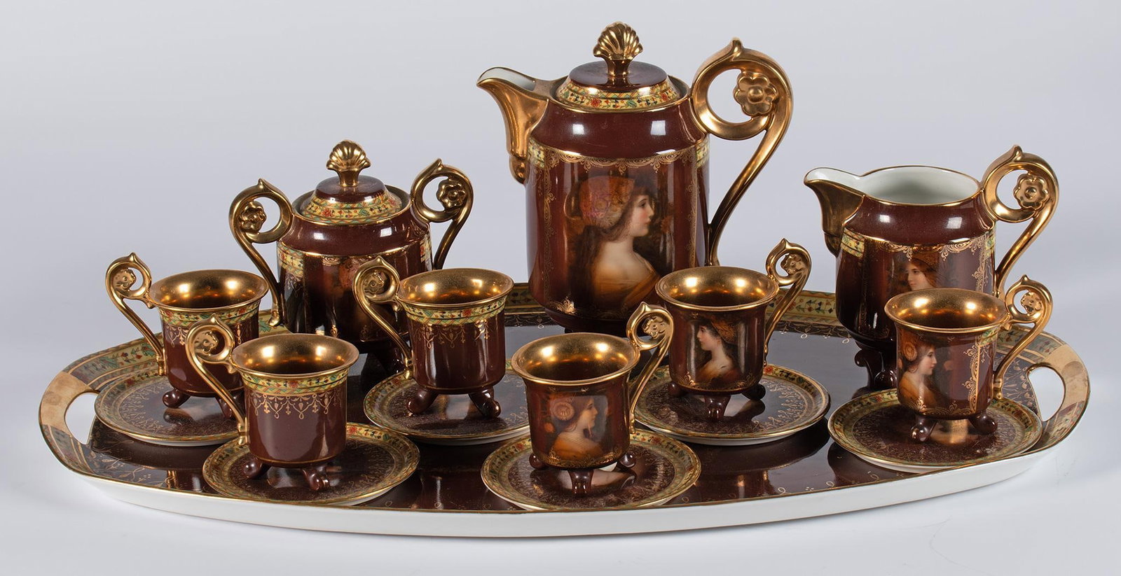 JKW Carlsbad German Vienna Style Porcelain Tea Service: Czech, late 19th century. A porcelain tea service by JKW Carslbad with mark and Vienna Beehive markings, overall tea service with hand painted foliate design with central profile portrait of a woman, 