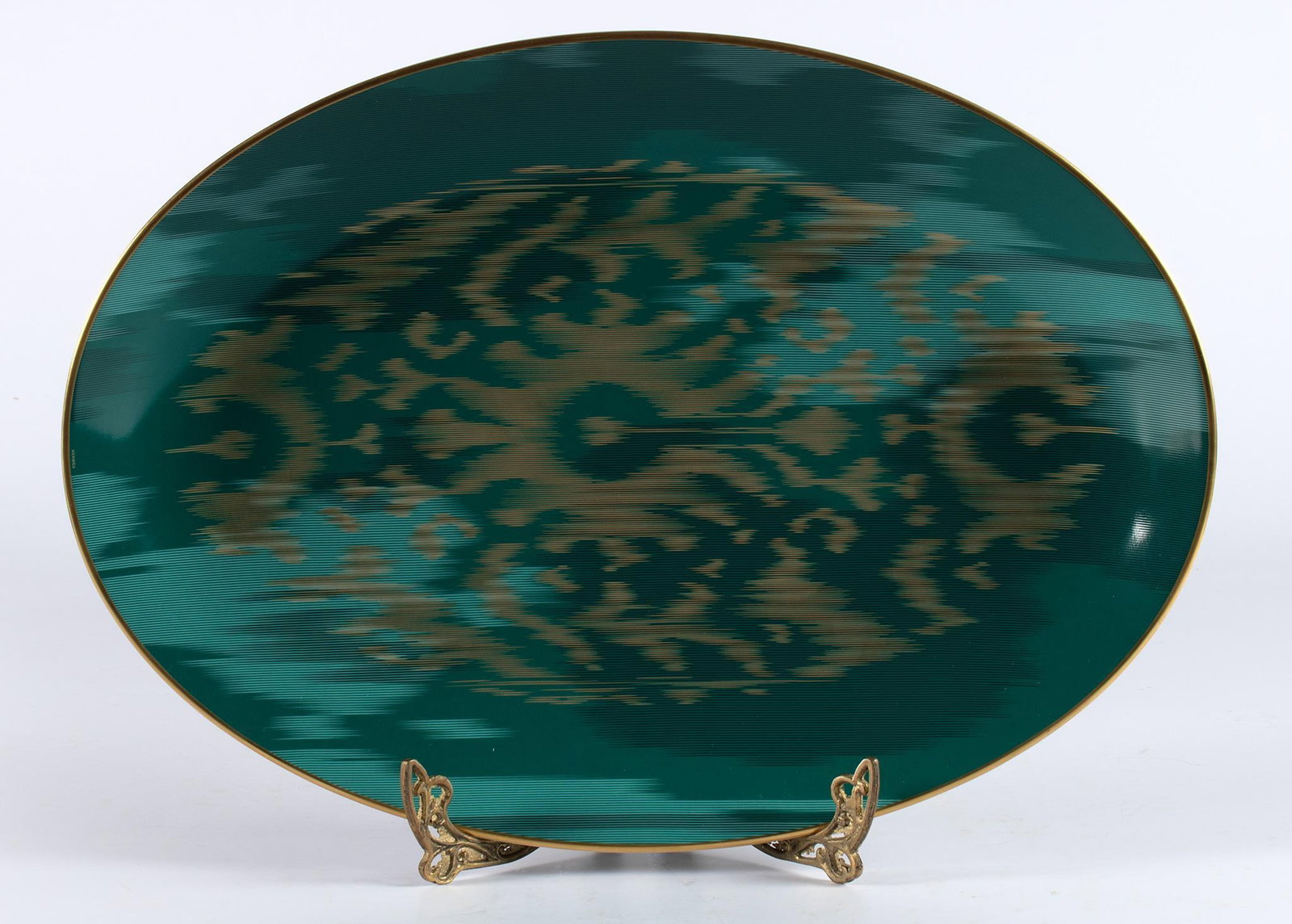 Hermes Voyage en Ikat Emerald Oval Platter: French, 21st century. A porcelain oval platter in emerald color by Hermes in the Voyage en Ikat pattern; 19 x 14 inches. Overall in very good condition. In original box, hallmark on underside.
