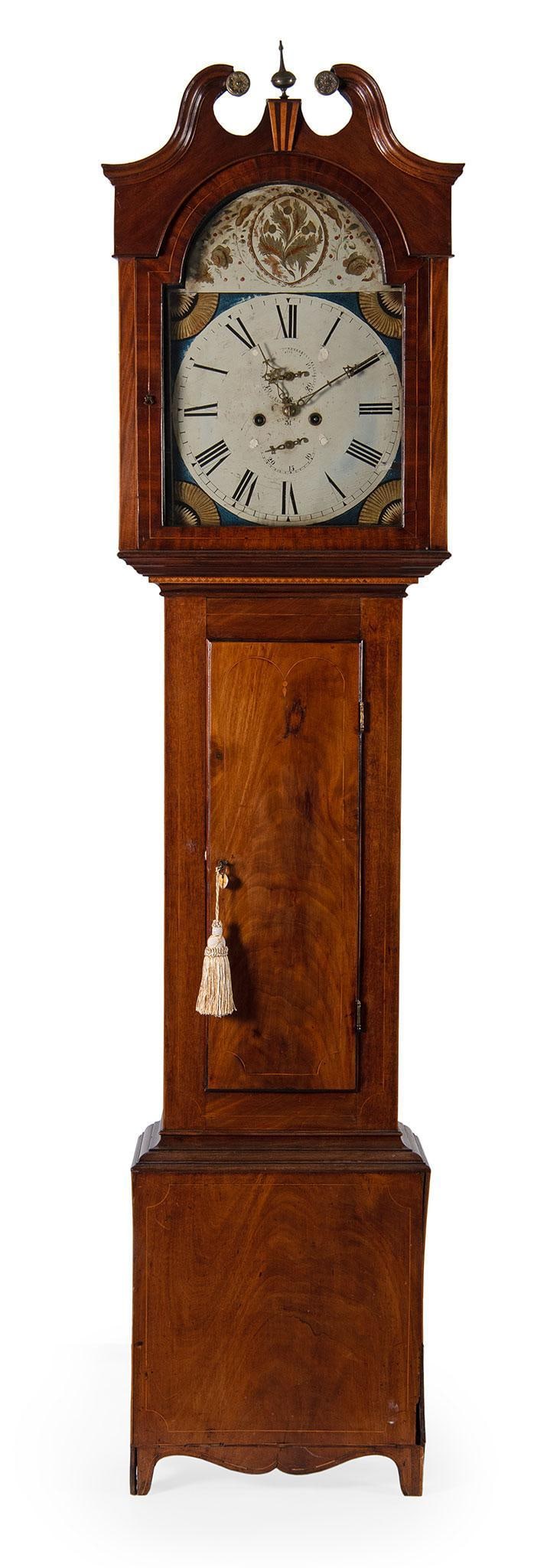 American Federal Tall Case Clock: American, 19th century. An American Federal tall case clock in mahogany, bonnet having a broken arch swan neck pediment with central inlaid plinth and brass rosettes, over a hand painted face with rom