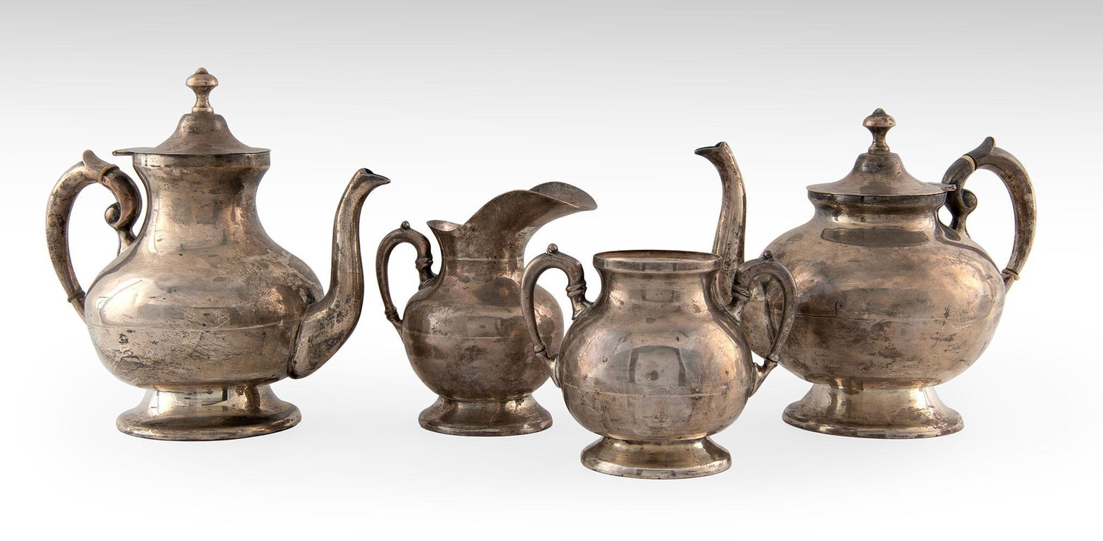 A Mexican Sterling Tea Service: Mexican, 20th century. A Mexican sterling tea service, lot includes two Mexican 925 marked tea post with bone inset handles plus a sugar and creamer; largest ht. 9, wd. 9, dp. 5.5 inches. Total weight