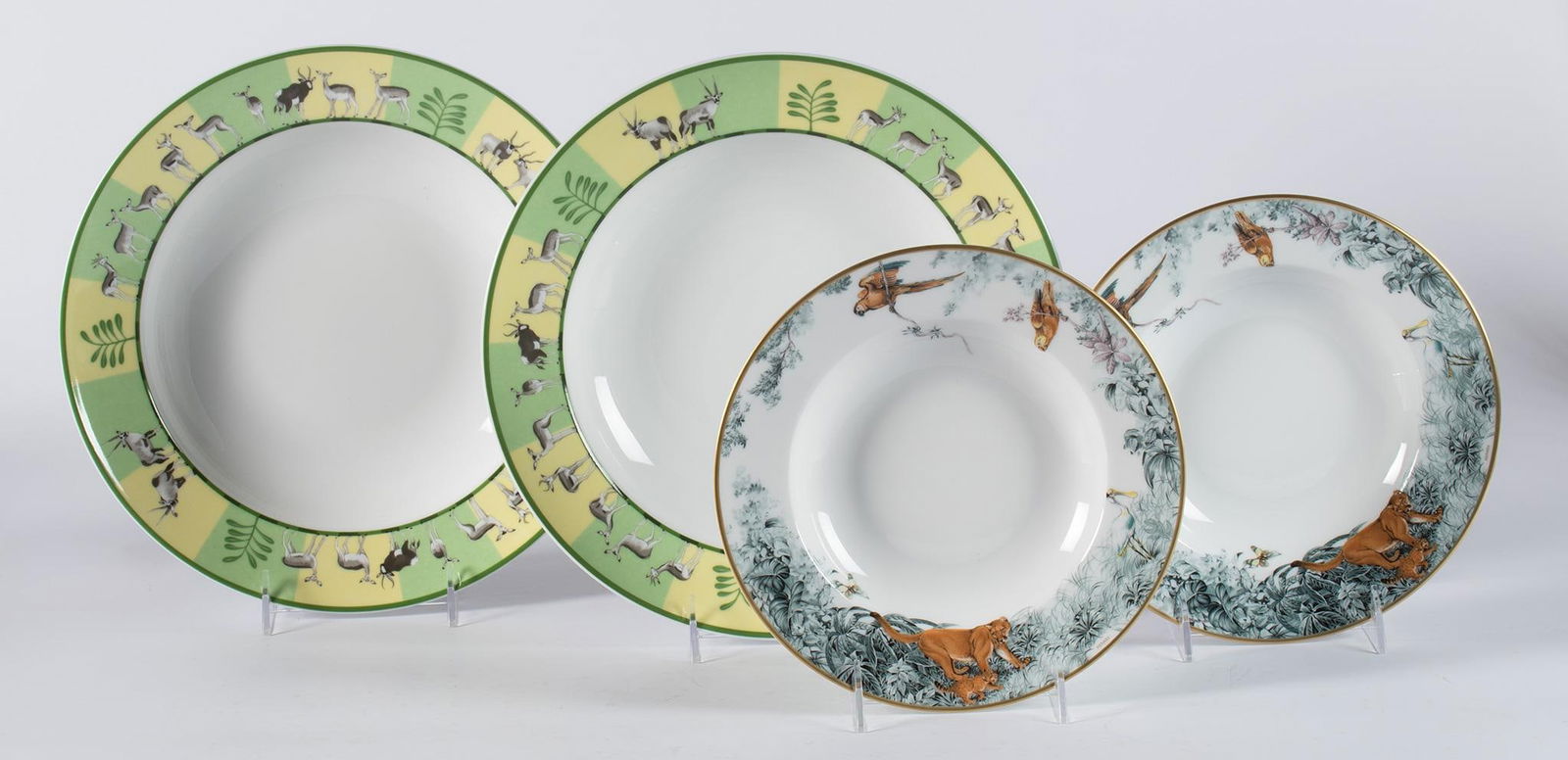 Hermes Wildlife Porcelain Dinner Service Pieces: French, 21st century. A group of four Hermes porcelain dinner service pieces in the Africa and Carnets A Equateur patterns, lot includes two Equateur soup bowls and two deep round platters in the Afri