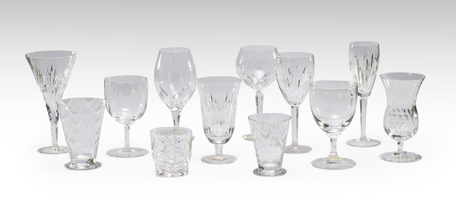 23 Pieces of Waterford Crystal Stemware: American, 20th century. A grouping of 23 various crystal stemware pieces by Waterford, lot includes, red and white wine, tumblers, dessert, and fluted crystal stemwares in various patterns. Overall ne