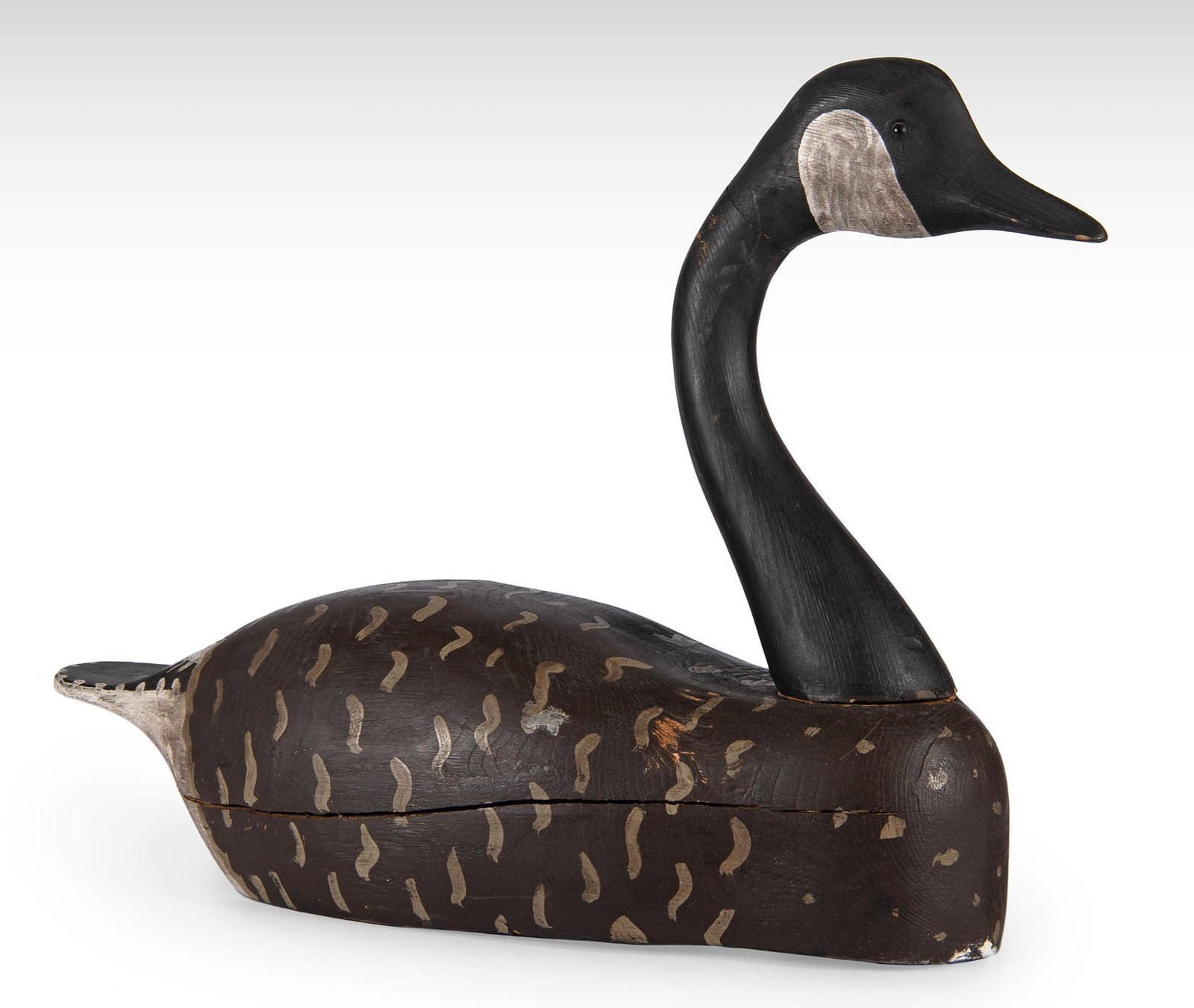 Carved and Painted Canadian Goose Decoy: American, 20th century. A carved and painted Canadian Goose decoy with glass eyes. ht. 16, wd. 22, dp. 7.25 inches. Overall good condition. Possible break and restoration to Goose neck.