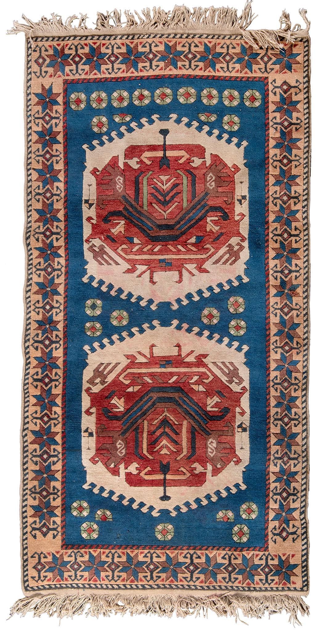 A Kazak Area Rug: Turkish, 20th century; 70 x 38 inches. Overall good condition. Some red dye in the beige areas.