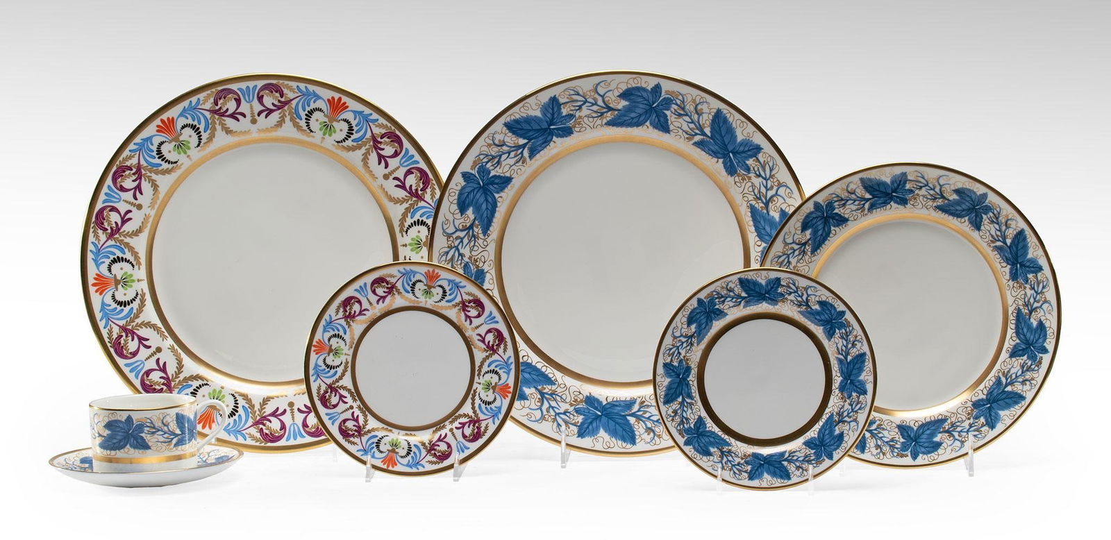 William Yeoward Hampton Court Porcelain Dinner Ware: English, 20th century. A group of 7 Hampton Court fine bone china dinnerware pieces by William Yeoward, lot includes a teacup and saucer, 2 bread and butter plates, a single dessert plate, and 2 dinne