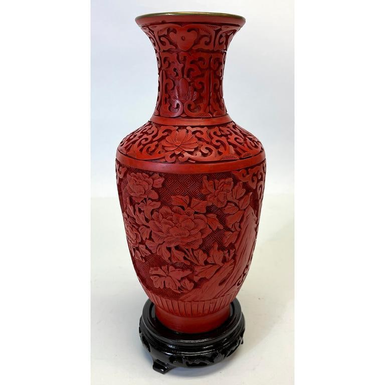 A Chinese Cinnabar Vase on Stand: Chinese, 20th century. A Chinese cinnabar vase, having overall foliate decorated body; ht. 9, dia. 4 inches (without stand). Overall good condition.