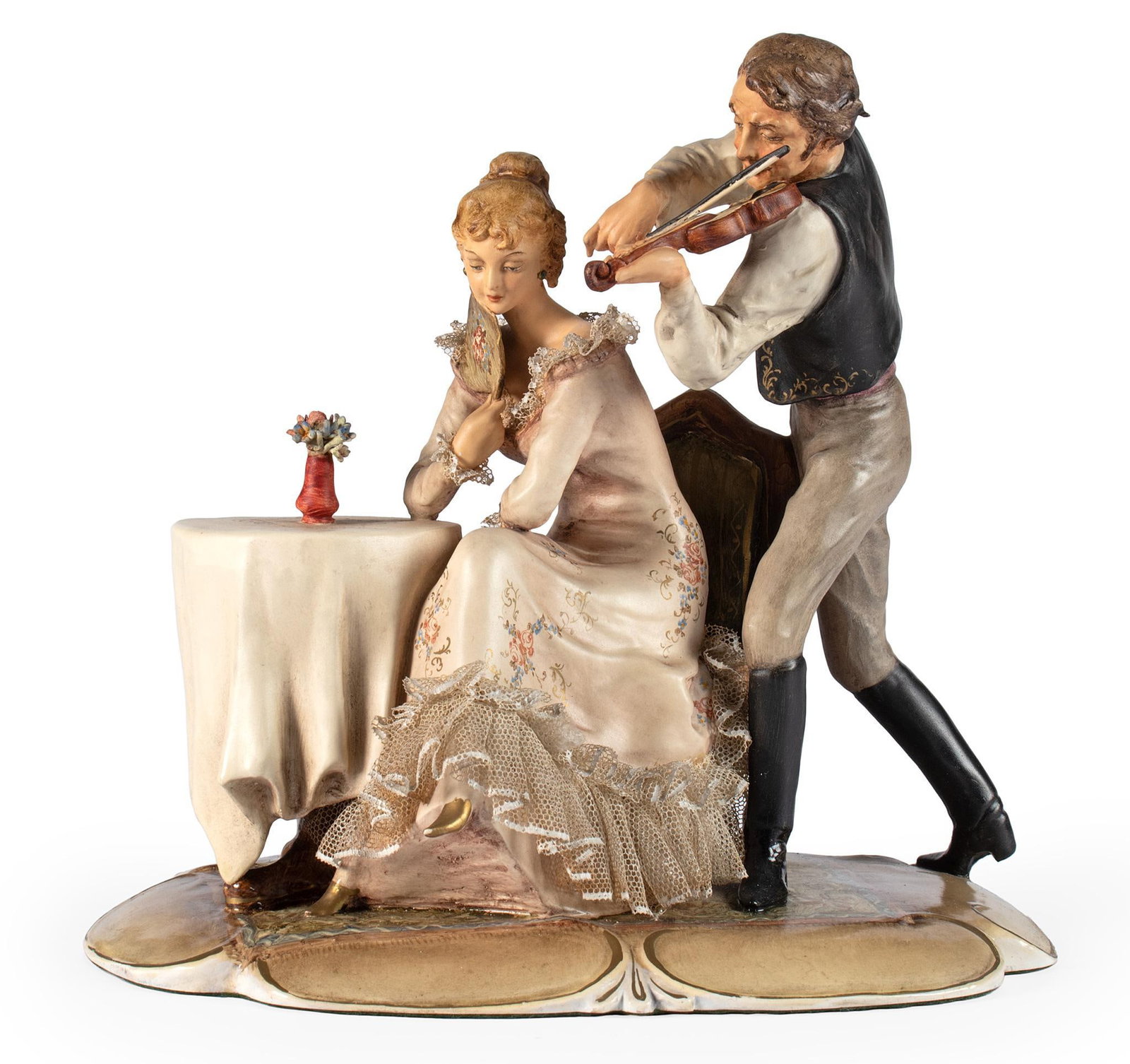 A Porcelain Courting Scene by Bosato: Italian, 20th century. A porcelain sculpture of a courting gentleman playing violin over a young lady's shoulder courting, painted porcelain sculpture marked on base with label on underside; ht. 8, wd