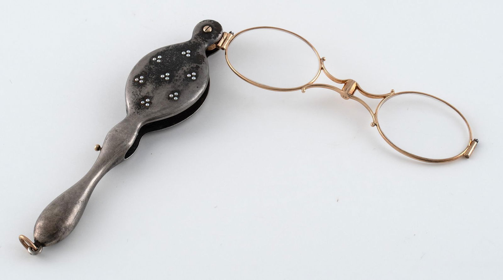 Antique Victorian Silver and Gold Lorgnette Glasses: American, 19th century. Victorian Lorgnette glasses, shaped silver case with inset pearl design and gold glasses; ht. 4.5, wd. 1.25 inches. Overall good condition. Release and glasses are functional.