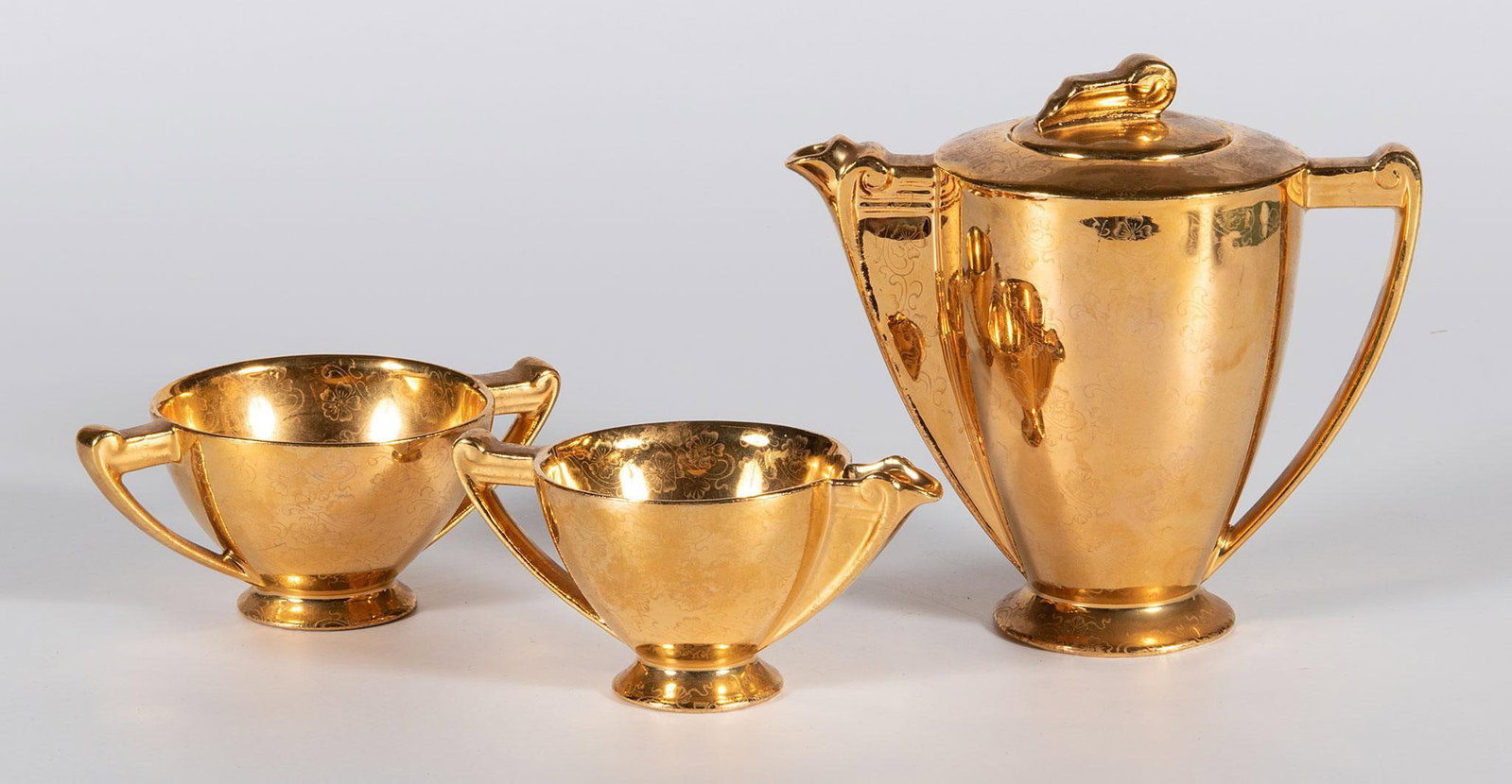 Lady Hamilton 22K Tea Servicewares: A grouping of three Lady Hamilton 22K plated tea servicewares, lot includes a teapot and two teacups; ht. 6, wd. 6.5, dp. 4 inches. Overall good condition.