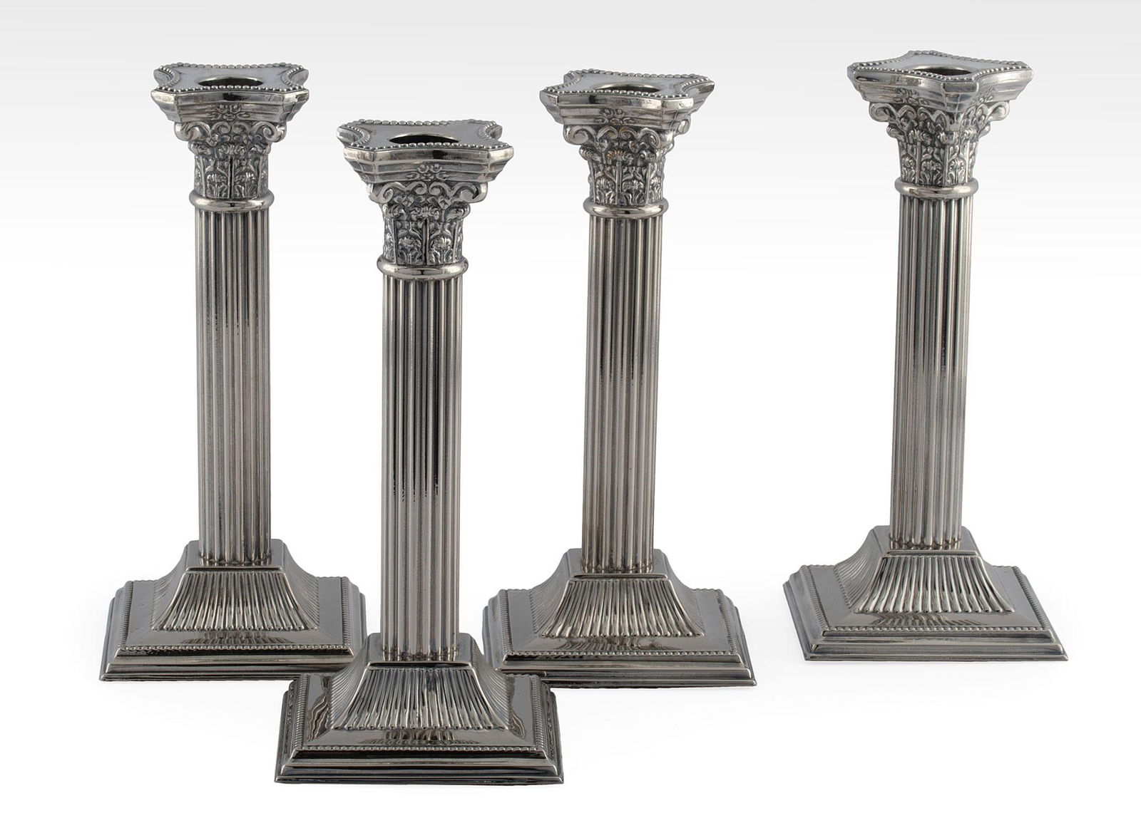A Group of Four Corinthian Column Weighted Silver Candlestick (1 of 2)