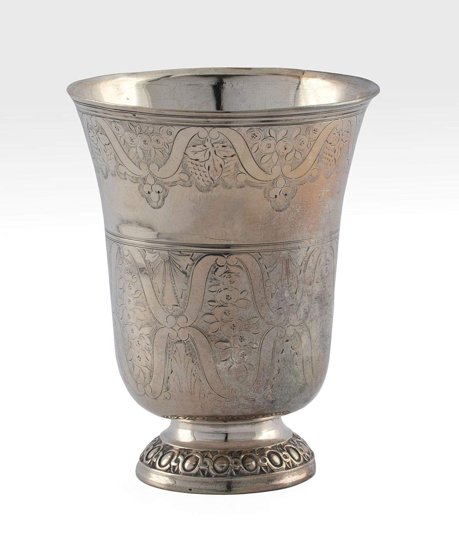 French 18th century Silver Tulip Wine Goblet: French, circa 1777. A tulip shaped wine goblet with foliate festoon decoration throughout body and round dragooned foot, heavily scratched French hallmarks to base underside; ht. 4.75 x dia. 3.5 inche