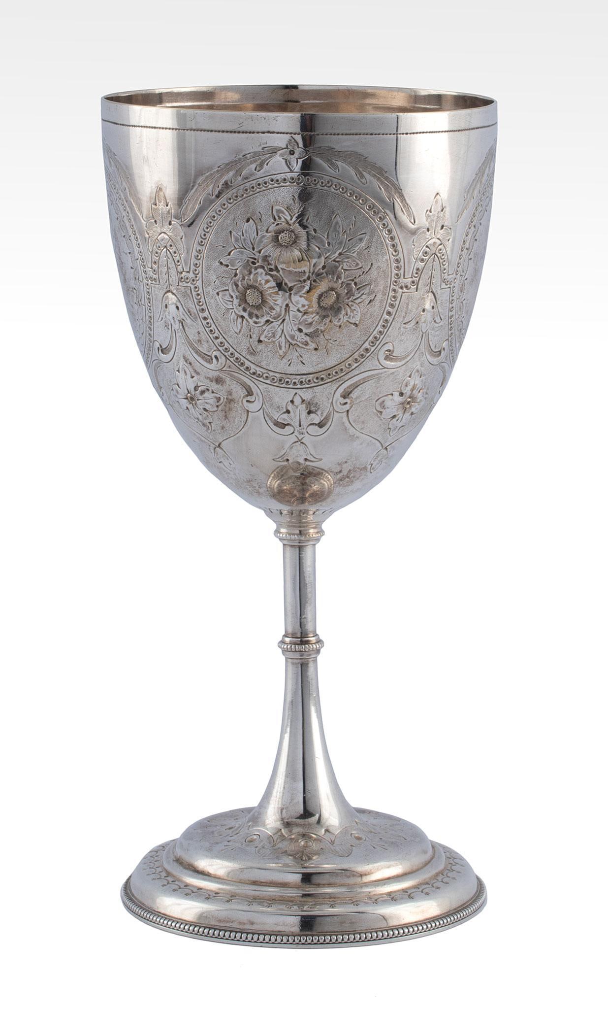 A 19th Century Silverplated Wine Goblet: English, circa 1865. A silverplated wine goblet, body with overall foliate panel design with beaded stem and round festoon decorated foot, no hallmarks present; ht. 8.25 x dia. 4 inches. Purchase at N