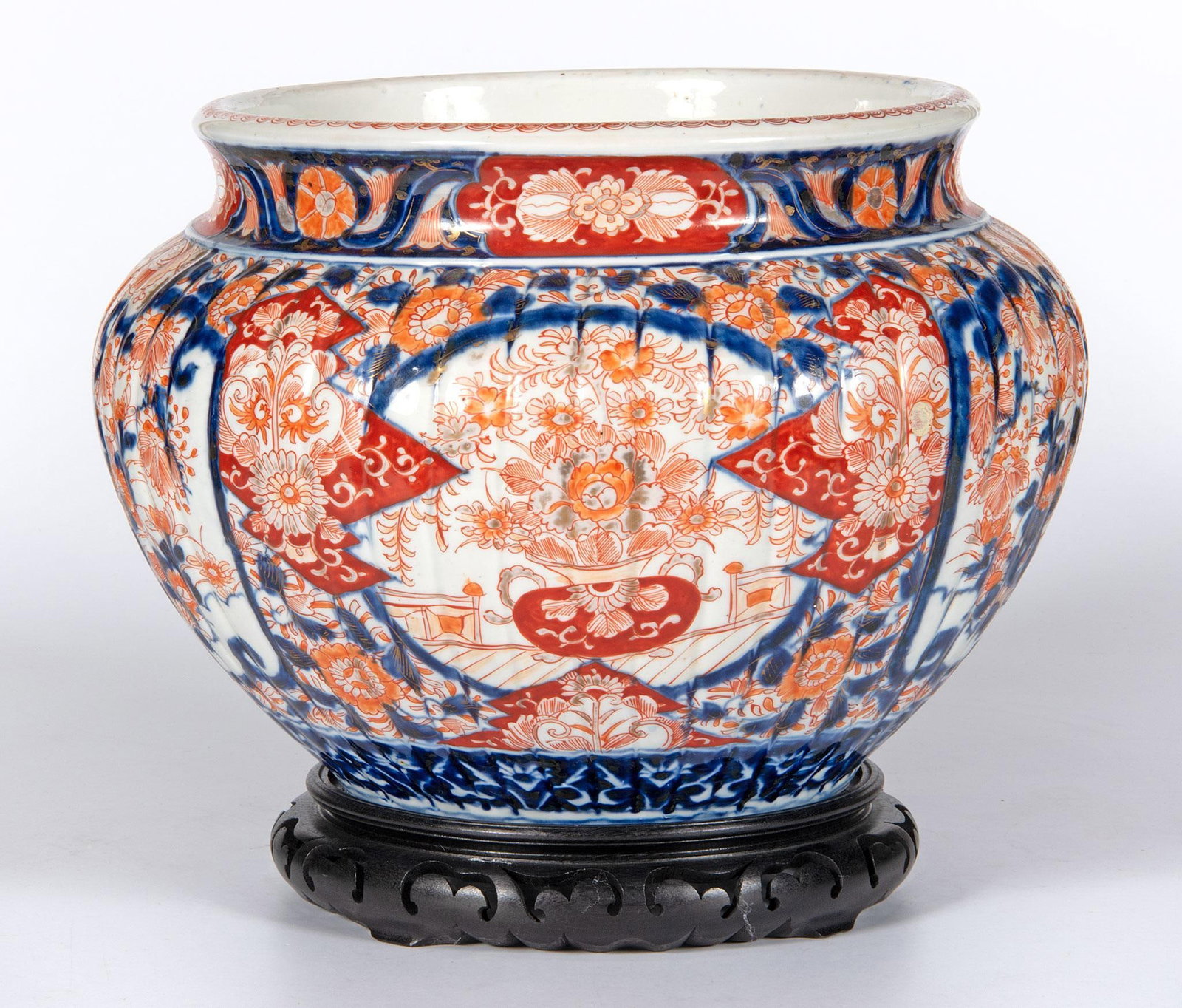 A Large Japanese Meiji Period Ribbed Imari Jardiniere: Japanese, 19th century. A Japanese Imari Meiji period jardiniere, body having four panel decoration of phoenix bird and bouquet with overall wildlife base pattern, ribbed body with decorated mouth and