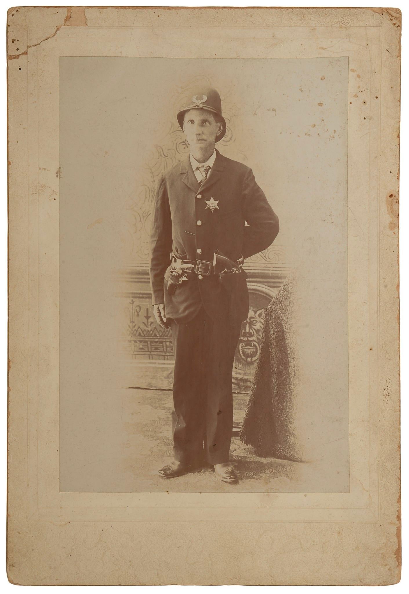 Large Format CDV 19th Century Photograph of Police Officer: Circa 1890s photo of a police officer in uniform. Large format, measuring approximately 7 x 10 inches. Photo shows that he has two Colt revolvers – one early piece and an 1890s pocket revolver. Can�