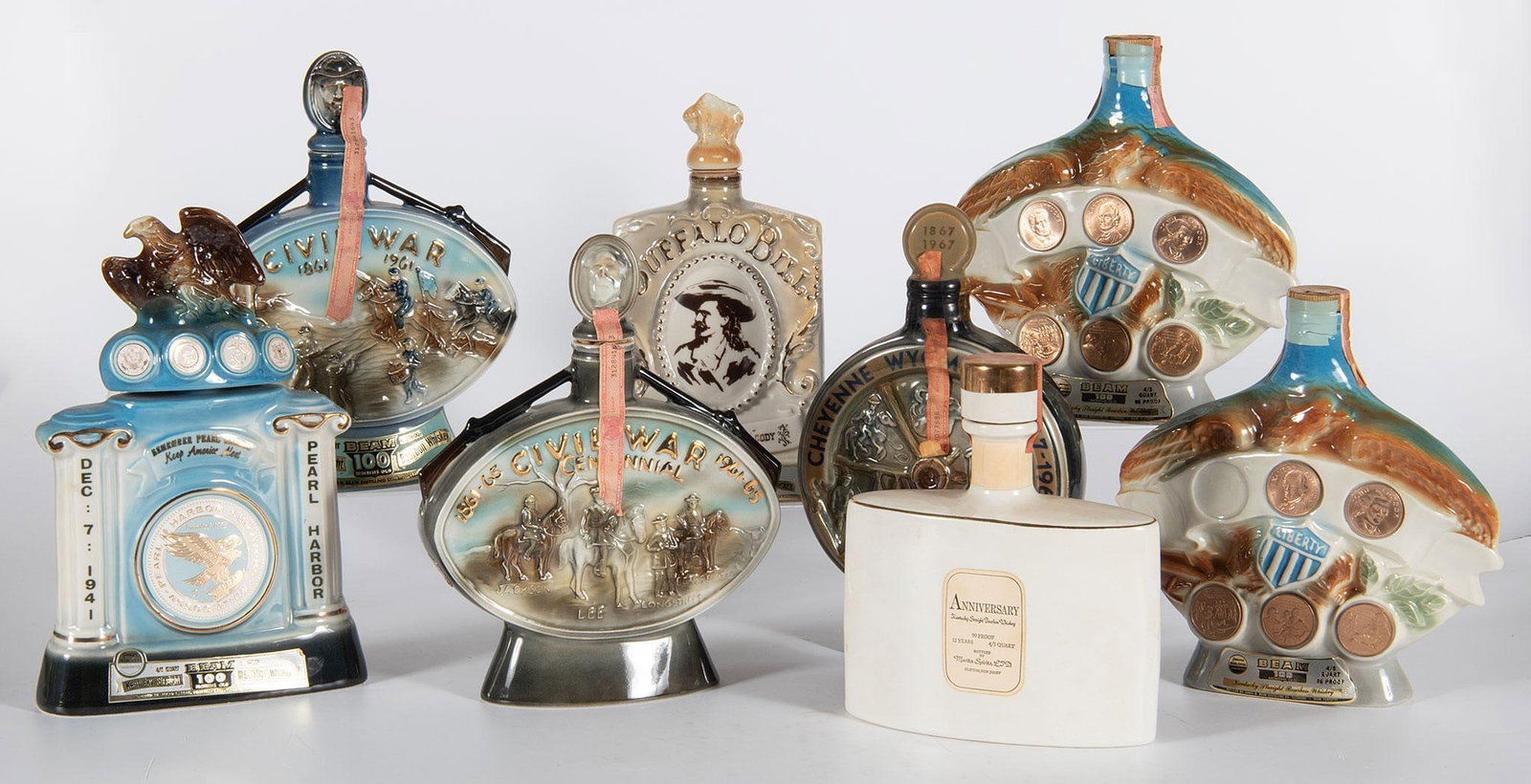 Vintage Jim Beam Historical Related Porcelain Decanters: Lot consists of 8 vintage Jim Beam porcelain decanters, including two Civil War Centennial, Thomas Edison125th Anniversary, Pearl Harbor Survivors, two Liberty (single missing one token), Cheyenne Cen