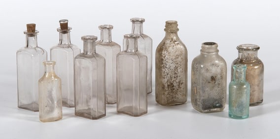 A Group of 11 Vintage American Glass Bottles or Apothecary Jars