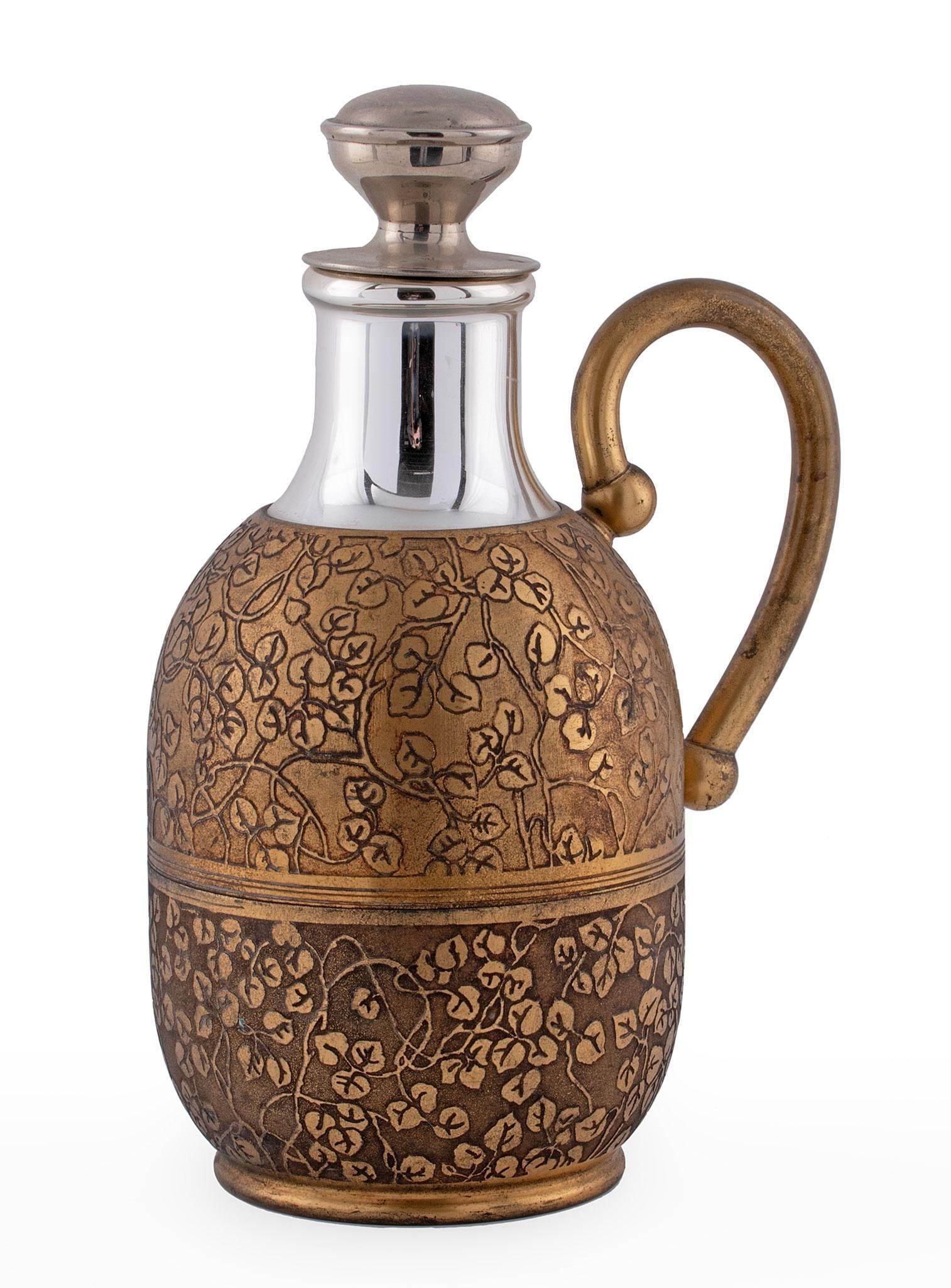 Vintage American Thermos Co. Gilded Thermos: American, 20th century. A gilded and foliate decorate American Thermos Co. decanter or thermos, marked on base with single handle; ht. 10.5, wd. 7, dp. 5 inches. Overall good condition.