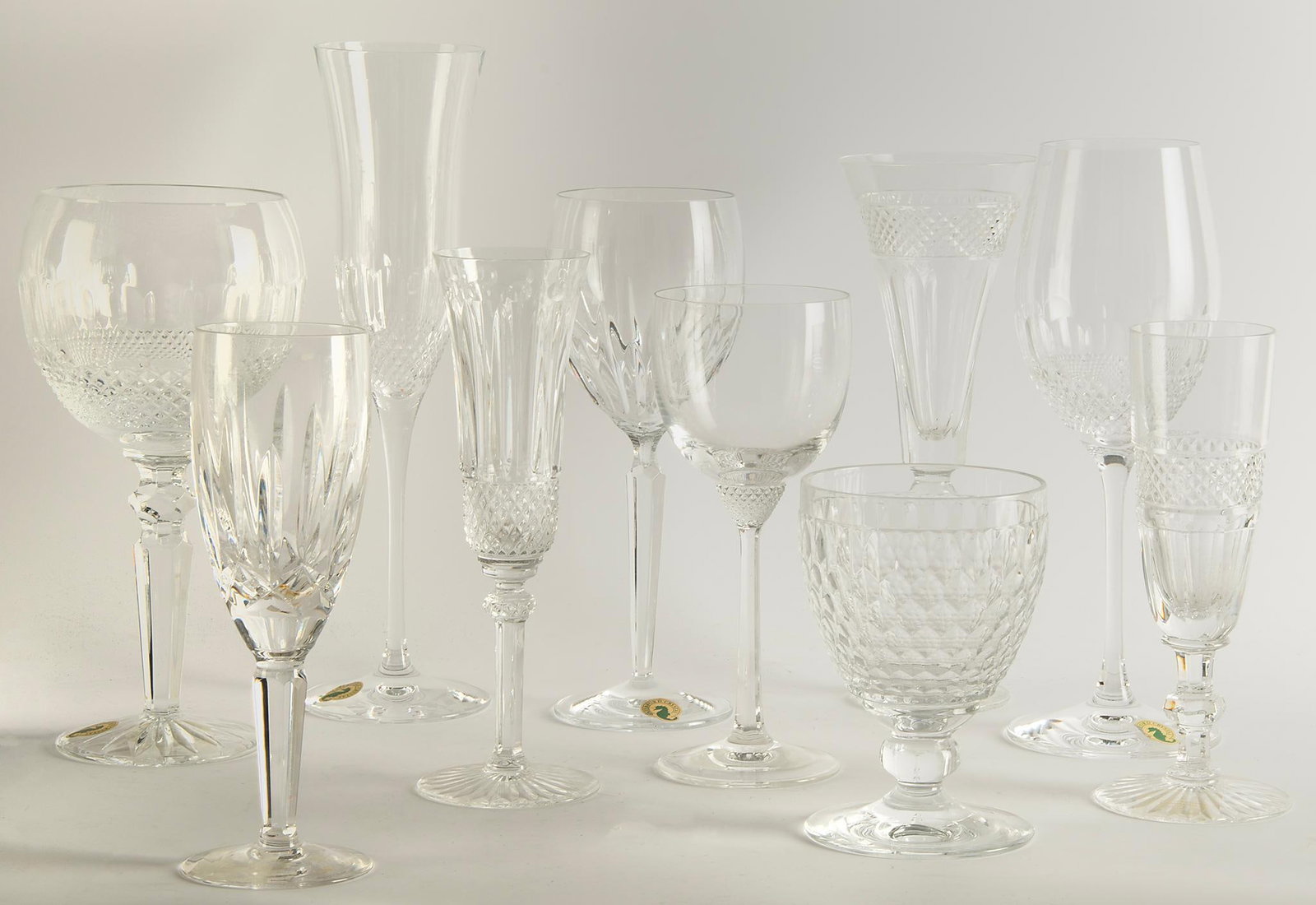Grouping of Various Waterford and St. Louis Cut Glass Stemware: Lot includes13 various made stemware glasses, including Waterford Colleen & Essence wine glasses, Tommy St. Louis champagne flute; largest ht. 11 inches. Overall good condition.