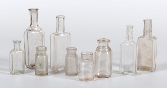 A Group of 9 Early American Clear Glass Bottles