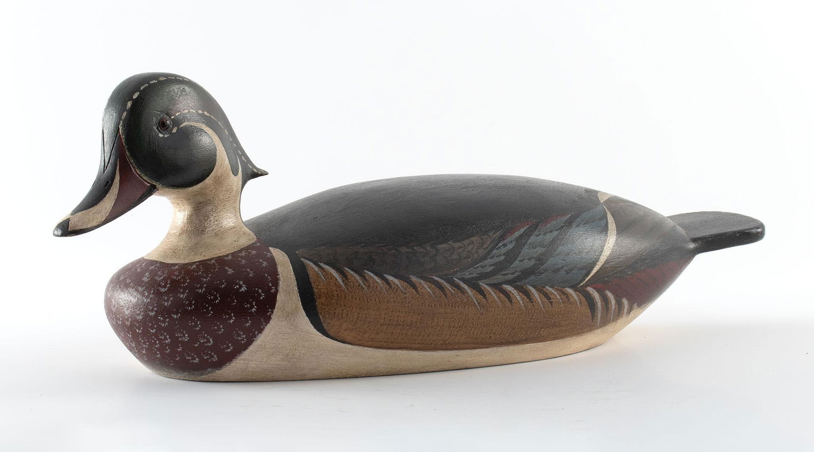 Vintage Carved and Painted Drake Duck Decoy by K.E. Delong: American (Hyannis, Massachusetts), late 20th century. A hand carved and painted drake decoy by K.E. Delong; ht. 4.5, wd. 11.5, dp. 4.5 inches. Overall good condition.