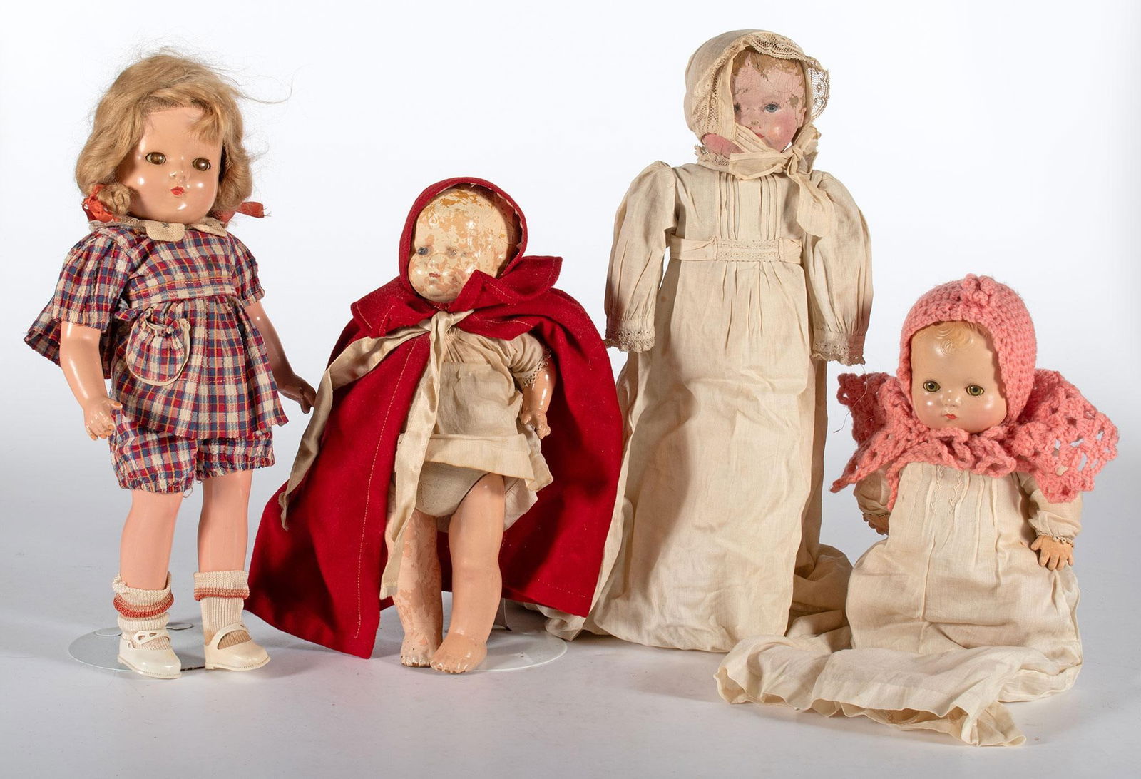 A Grouping of Antique Dolls: American, 20th century. A grouping of vintage composition dolls, including a Patsy Baby Doll, Shirly Temple Doll, and Effanbee Little Red Riding Hood doll plus single unmarked vintage painted canvas d