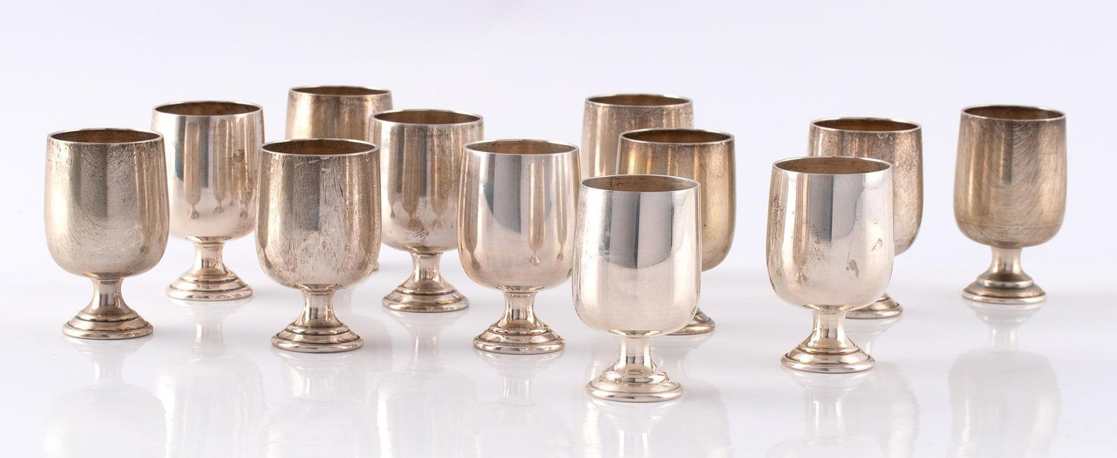 A Group of Baldwin and Miller Sterling Cordials: American, 20th century. A group of 12 sterling cordials by Baldwin & Miller, each with hallmark marked sterling; ht. 2, dia. 1.25 inches. Total weight of 252 grams. Overall good condition.