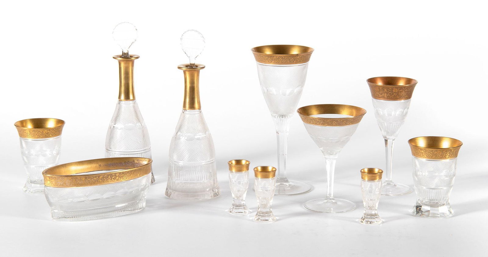 Suite of Moser "Splendid" Gold Stemware: Czech, 20th century. A suite of Moser "Splendid" stemware pieces, lot includes 9 water tumblers (4.25"), 10 tumblers (3"), 3 champagne (5.75"), 6 Red wine (8.75"), 4 White wine (7"), 2 decanters/caraf