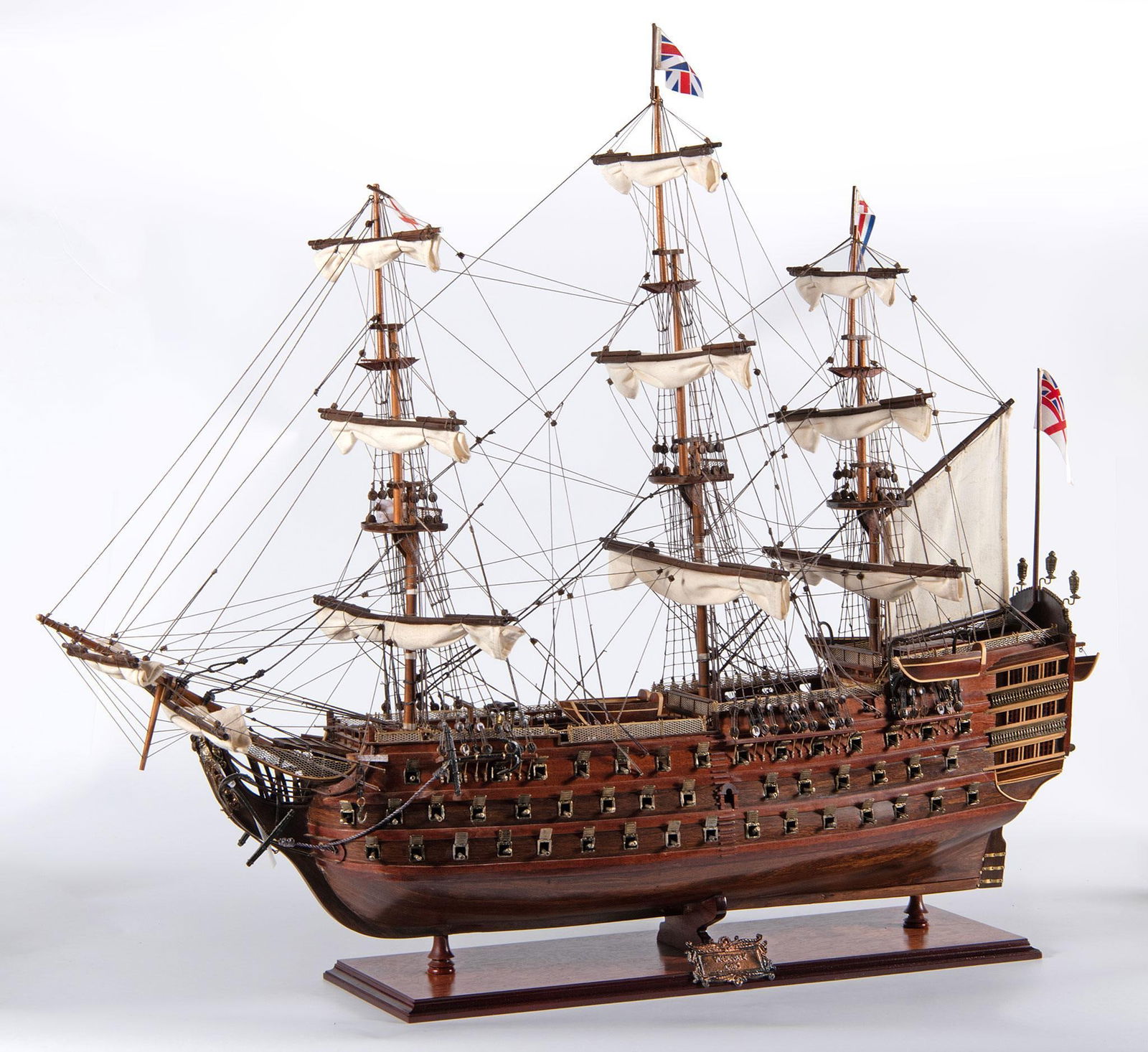 Large Scale H.M.S. Victory Model Ship: Scale model of the H.M.S. Victory, a British flagship launched in 1765 and famous for defeating the Franco-Spanish fleet in the battle of Trafalgar in 1805. Mounted inside a glass and carved wood case