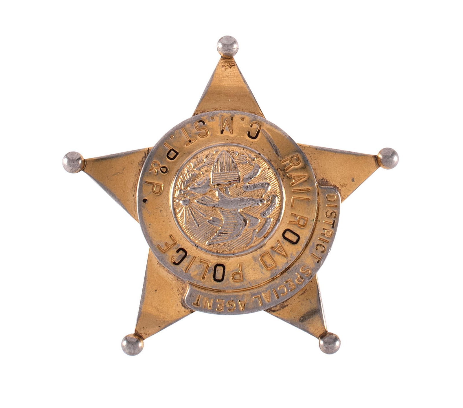 Milwaukee Road District Special Agent Badge: An obsolete five-point star Milwaukee Road District Special Agent Railroad Police Badge with damaged pinback. Back is marked CH Hanson; 2-3/4 x 2-3/4 inches. Overall good condition. Purchased from Kra