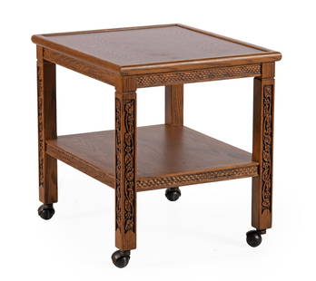 Romweber VIking Oak Two Tiered Side Table: American, 20th century. A Viking Oak two tiered side table by Romweber of Cincinnati, Ohio, having a square surface above a notch carved apron, rising on straight square legs with grapevine carvings t