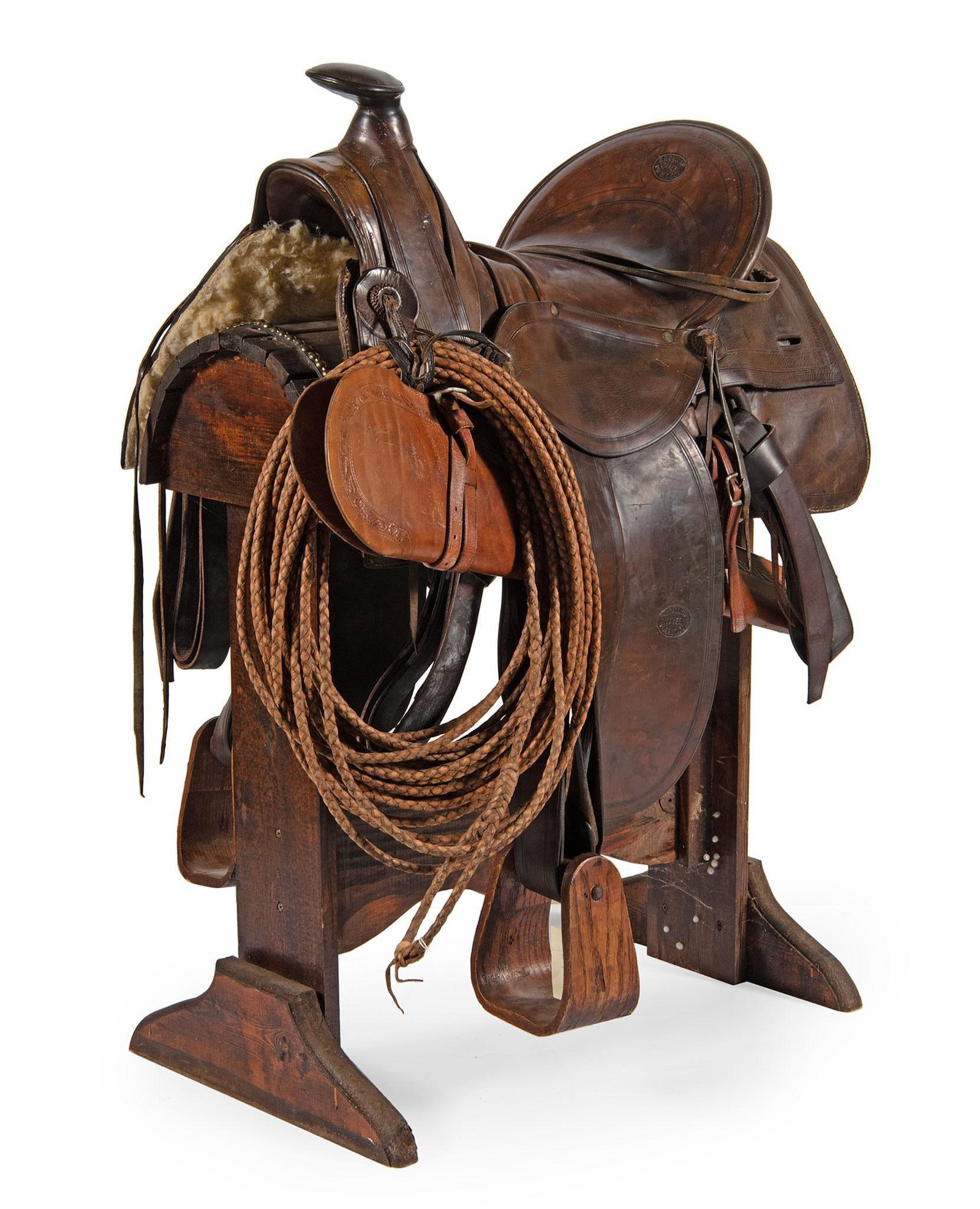 Rare S.C. Gallup Leather Saddle: Pueblo Colorado, last quarter 19th century. A stamped S.C. Gallup maker Pueblo Colorado leather saddle with wooden stirrups, saddle blanket, leather rifle scabbard, and La Reata. Items besides the sad