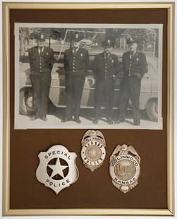 Collection of Ellinwood Kansas Police Badges: Circa 1940s Ellinwood, Kansas badge collection. Frame of three badges and a photo with officers identified on the back. Metal frame is approximately 8 x 10 inches and has no glass.