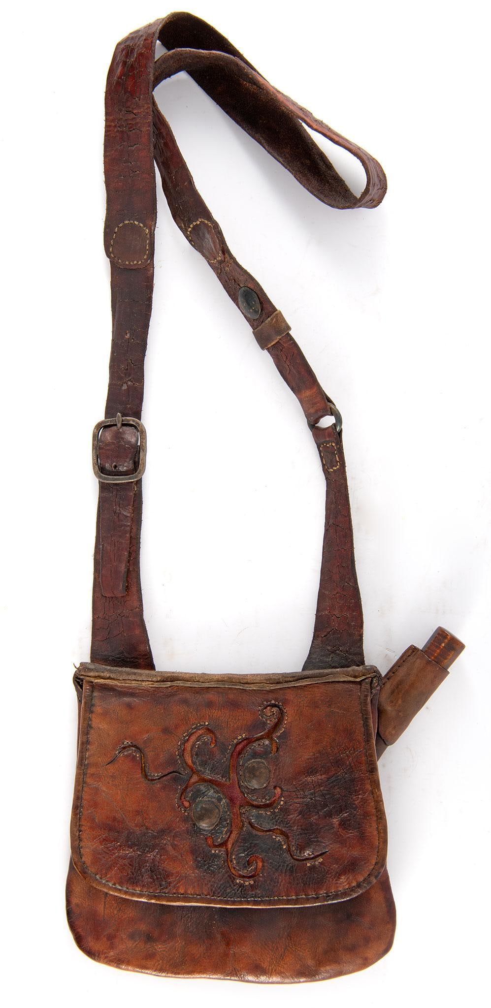 Early 20th Century Handcrafted Possible Bag with Sheath and Knife: A well-crafted possible bag made from medium-weight steer hide and featuring authentic hide and period knife. The design includes a hand-forged iron buckle on a durable leather strap, single interior 