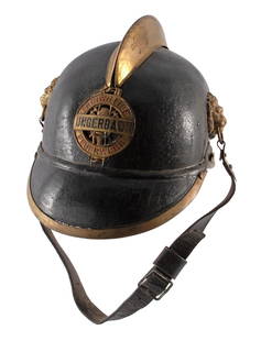 Original Pre-War WWI German Leather Fire Brigade Helmet: Pickelhaube style leather body with brass comb brass trim and fittings, front badge reading Freiwillige Feuerwehr fronting ladders, axes and ropes. All original condition. Overall good condition.