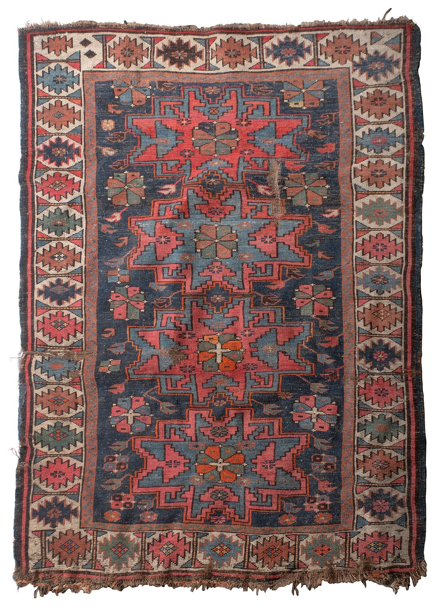 Antique Caucasian Area Rug: Caucasian, 20th century. A Caucasian area rug; 53 x 39 inches. Overall good condition with wear throughout. Frey to perimeter and edges.