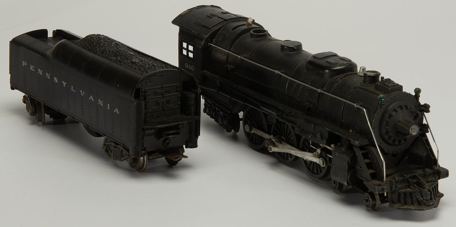 Postwar Lionel O Gauge 646 Steam Locomotive with 2046W Tender: Postwar, O gauge, locomotive 646, and O27 gauge tender 2046W-50. Tender has minor chip to top corner. Overall good condition.